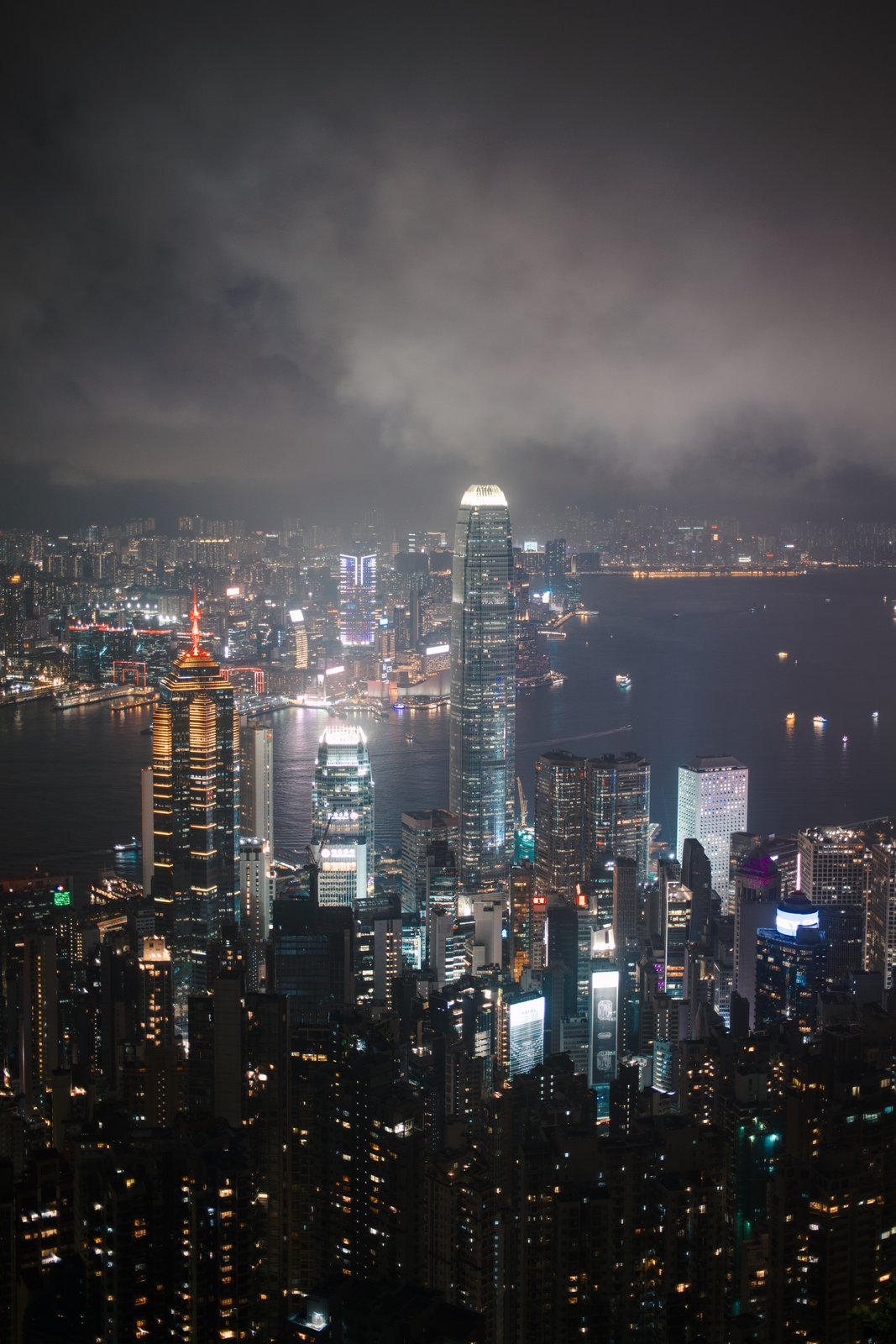 Victoria Harbour and the skyline at night under low cloud, seen from the Peak