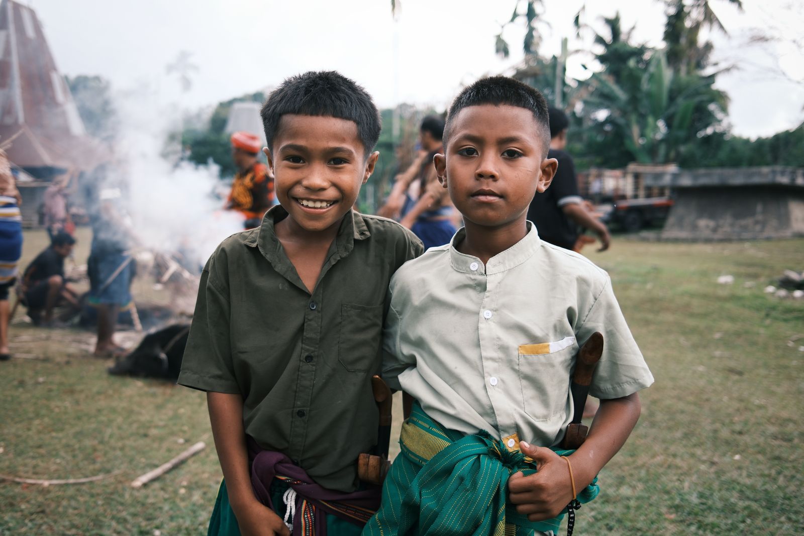 Two boys standing side by side in smoke